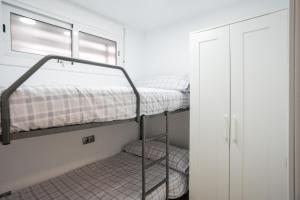 a bedroom with two bunk beds and a window at FORMENTOR Apartment in Salou