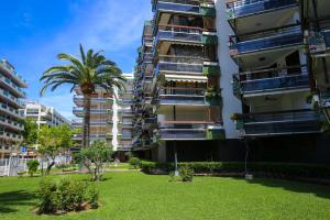 an apartment building with a lawn in front of it at FORMENTOR Apartment in Salou