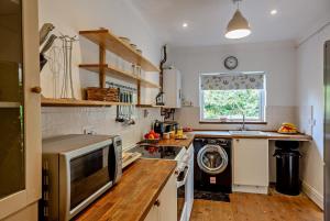 a kitchen with a washer and dryer in it at 3 Bed in Harlech oc-g33093 in Harlech +21 photos