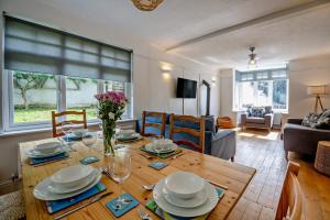 a dining room and living room with a wooden table at 3 Bed in Harlech oc-g33093 in Harlech