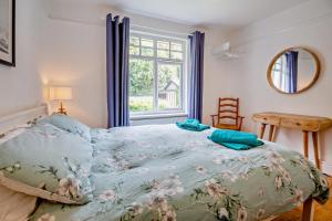 a bedroom with a bed and a window at 3 Bed in Harlech oc-g33093 in Harlech
