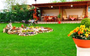 a garden with a rock flower bed in the yard at Relax pozar in Kato Loutraki