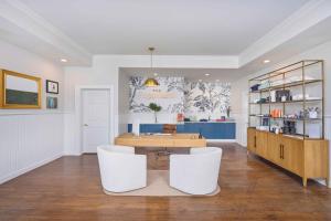 a room with a table and two white chairs at The Sagaponack in Sagaponack