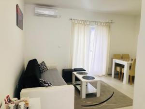 a living room with a couch and a table at Apartman DB in Višegrad
