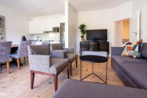 a living room with a couch and chairs and a table at The Ya Ya Apartment in Stellenbosch