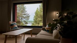 a living room with a couch and a large window at VITA AQUA Kątno in Kątno