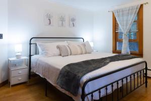 a bedroom with a bed and a window at Naples Village Retreat - Heart of the Lakes Region in Naples