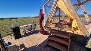 a wooden deck with a gazebo and a stage at La bulle ico in Valensole