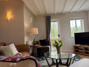 a living room with a couch and a table at North Lodge at Pudleston Court in Hatfield