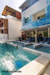 a villa with a swimming pool and a house at Pousada Bahia Inn in Morro de São Paulo