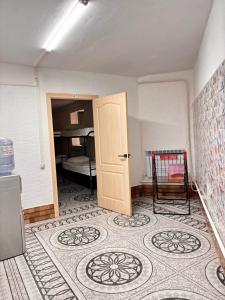 an empty room with a door and a room with a bedroom at Adeke hostel in Atyraū