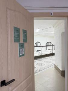 a door leading into a room with two beds at Adeke hostel in Atyraū