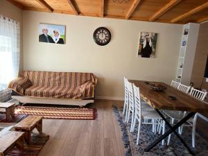 a living room with a couch and a table at Bujtina Seyna in Librazhd