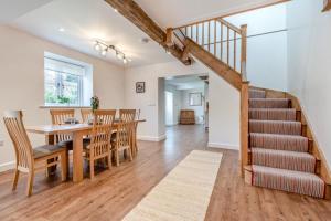 a dining room and living room with a table and a staircase at 2 Bed in Blandford St. Mary oc-s33308 in Charlton Marshall