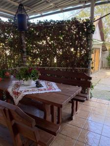 a wooden table and bench in a garden at Садиба Ангеліка in Csetfalvát +15 photos