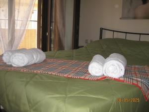 two rolls of towels sitting on top of a bed at Forest Breeze-1 - JM Rentals in Stení Dhírfios