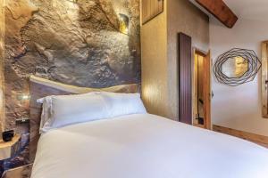 a bedroom with a white bed and a stone wall at 2 Bed in Morecambe oc-s33326 in Morecambe