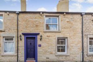 a brick building with a blue door and windows at 2 Bed in Morecambe oc-s33326 in Morecambe