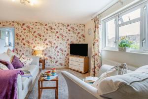 a living room with a couch and a tv at 1 Bed in Saundersfoot oc-t33404 in Kilgetty