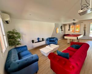 a living room with two blue and red couches at L'Hacienda Soléa in Culmont