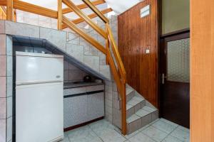 a kitchen with a staircase and a white refrigerator at Rooms Mat in Vir +28 photos