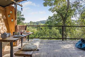 a wooden deck with a table and a view of trees at 2 Bed in Hay-on-Wye oc-h33385 in Hay-on-Wye