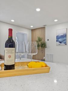 a bottle of wine and two glasses on a counter at Vacation Villa in Tampa 17 Guest in Tampa