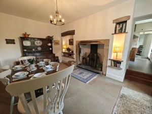 a dining room with a table and a fireplace at 3 Bed in Newton oc-n33394 in Wall Houses +18 photos