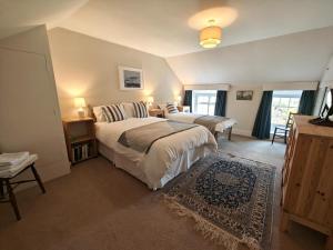 a bedroom with two beds and a room with two windows at 3 Bed in Newton oc-n33394 in Wall Houses