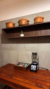 a wooden table with a blender on top of it at Tanti in Reyes