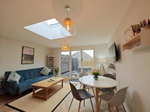 a living room with a blue couch and a table at 3 Bed in Shanklin oc-w33402 in Shanklin