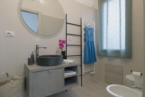 a bathroom with a sink and a mirror at Affittacamere La Violica in Villacidro +38 photos