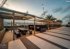 a rooftop patio with tables and benches on a building at The Sóng Apartment Vũng Tàu - Căn Hộ Du Lịch Biển Vũng Tàu - SuSu Homestay in Vung Tau