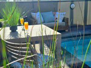 a patio with a couch next to a pool at 9 on Winkle Boutique Guesthouse in Cape Town