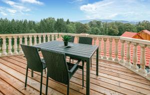 a black table and chairs on a wooden deck at 2 Bedroom Lovely Apartment In Stainz in Stainz