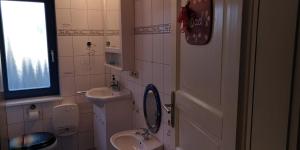 a small bathroom with a sink and a toilet at Märchengarten Hänsel und Gretel in Putbus
