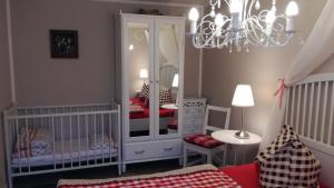 a baby room with a crib and a large mirror at Märchengarten Hänsel und Gretel in Putbus