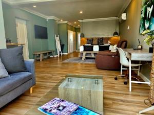 a living room with a couch and a table at 9 on Winkle Boutique Guesthouse in Cape Town