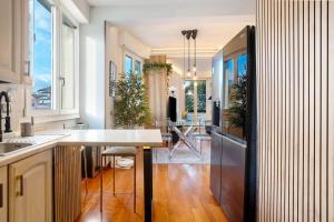 a kitchen with a table and a dining room at Appartamento 3 in Viareggio