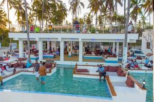 a group of people in a pool at a resort at Kilifi Pearl Beach Resort in Kikambala