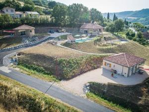an aerial view of a house on a hill at Les Raspes du Samphy in Saint-Victor-et-Melvieu