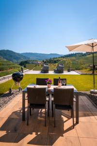 a table with chairs and an umbrella on a patio at Corner 28 in Oberkirch