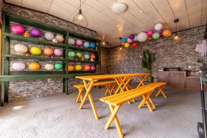 two picnic tables in a room with colorful eggs on the wall at Lax奈良 奈良観光に便利な和モダン古民家 最大12名 グループや家族旅行に最適 in Nara