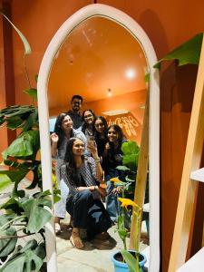 a group of people posing in front of a mirror at OffDuty Hostel Koregaon Park in Pune