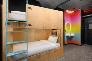 a room with a bunk bed with a ladder at JO&JOE Budapest in Budapest