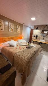 a bedroom with a large bed in a room at Hotel da Inês in Visconde De Maua