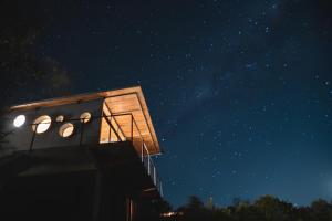 a building with lights on it at night at Villa Toscana I - Gran Vista y Tranquilidad in Villa Serrana