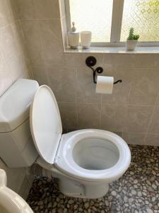 a white toilet in a bathroom with a window at Studio near Airport City Centre - 2317 in Highlands +26 photos