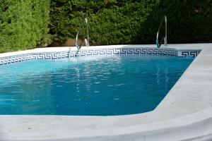 an empty swimming pool with blue water in it at Casa familiar en la playa con piscina in Teià
