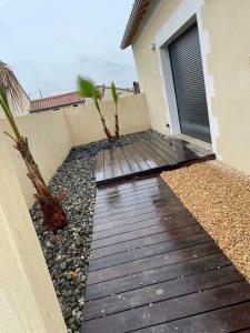 a wooden walkway in front of a house at Love room in Paizay-le-Chapt